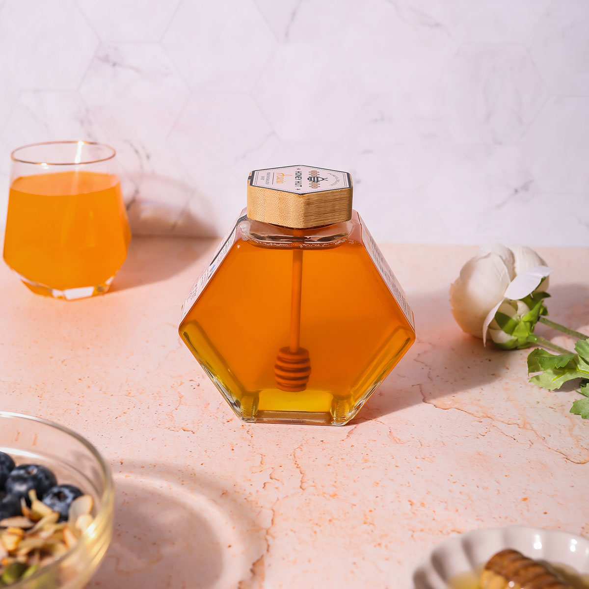 a glass of orange juice sitting on top of a counter 